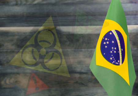 The concept of the COVID-19 epidemic in Brazil. a fragment of the flag of Brazil on a colored...