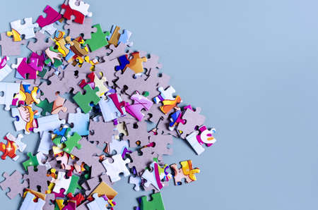 Scattered puzzles with drawings on a colored background close-up. Close-up copy space puzzlesの写真素材
