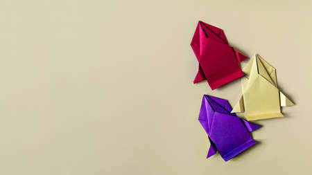 Conceptual paper cars of yellow, purple and red colors on a colored background close-up. Racing cars made of colored origami paperの写真素材