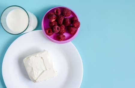 Ingredients for making a milkshake milk, ice cream raspberry berries on a light background top view. The concept of making a simple milkshake is a place for textの写真素材