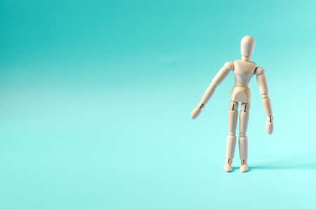 The figure of a surprised wooden man, on a light background. Dummy of a wooden man on a colored background copy spaceの写真素材
