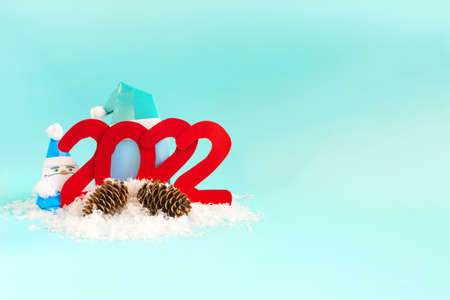 Christmas screensaver with the number 2022 with a color decor on a bright blue background. A bright New Year's card.の写真素材