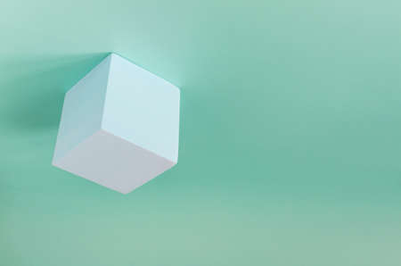 Abstraction a foam light cube is fixed at the top on a light background a place for textの写真素材