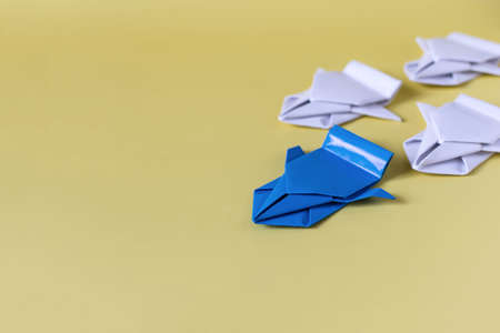 The concept of competition. The bright paper machine is ahead of the white nondescript machinesの写真素材