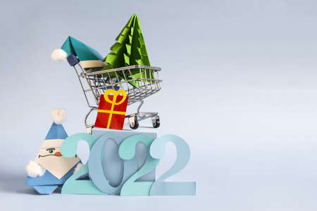 Cheerful Christmas card blue Santa Claus number 2022 and color decor on a bright blue background. New Year's background copy space.の写真素材