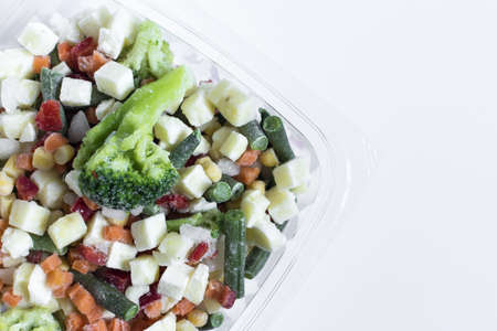 Frozen vegetables in transparent dishes on a light background. The concept of quick-frozen productsの写真素材