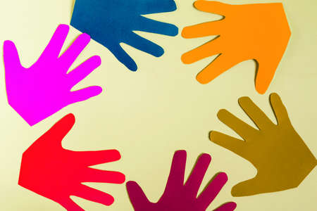 Abstract background multicolored palms made of thick paper on a colored background close-up.の写真素材