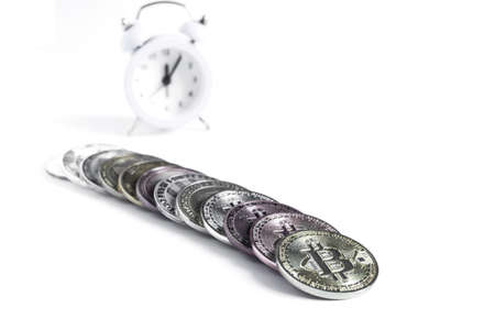 Metal coins of various cryptocurrencies and watches in the backgroundの写真素材