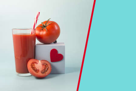 Abstract color two-zone background with tomato juice, blue podium and copy space tomatoesの写真素材