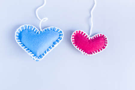 Color background with red and blue hearts on white threads, abstract background.の写真素材