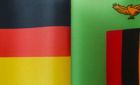 fragments of the national flags of Germany and the Republic of Zambia close-upの写真素材