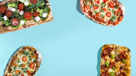 Banner of bright blue pinsa and pizza of different sizes with meat, vegetables and cheese close-up copy space.の写真素材