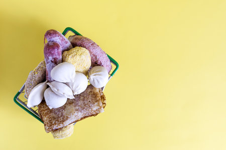 A basket with semi-finished products on a yellow background of kopi space. Products for fast...