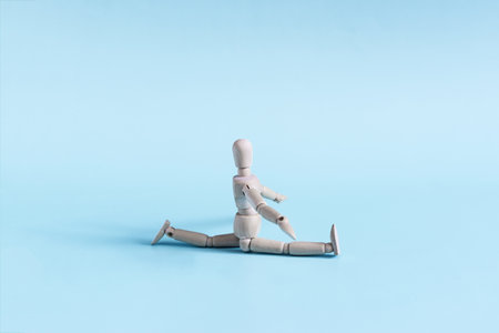 The figure of a wooden one does the splits in close-up. physical exercises and gymnastics.の写真素材
