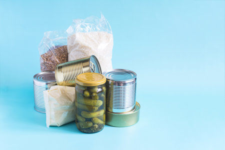 A set of long-term storage products. Various cereals, canned food close-up on a light backgroundの写真素材