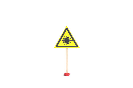 Warning sign about laser radiation yellow triangle on a white background, isolateの写真素材