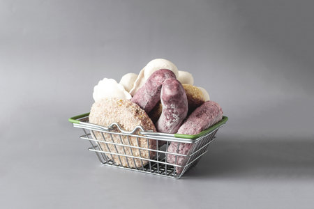 A full basket of various semi-finished products for quick cooking on a light background close-up.の写真素材