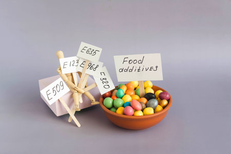 The concept of using food additives and information signs in close-up on a light background. The...