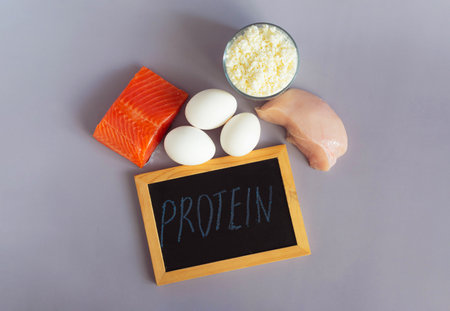 Products containing a large amount of protein in their composition, close-up on a light background and the inscription on a dark sign "Protein"の写真素材