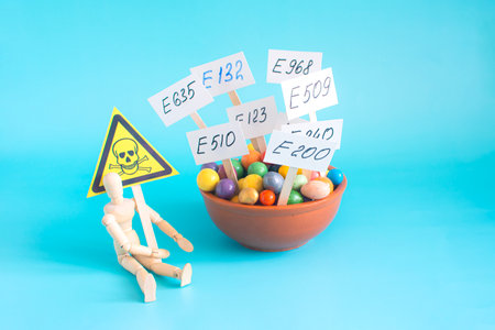A cup with various food additives in close-up on a light background. Warning about the deadly dangers of uncontrolled use of dietary supplementsの写真素材