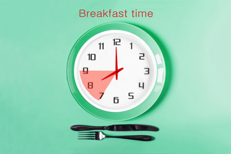 The clock shows eight o'clock in the morning, breakfast time. Clock face close-up on a light backgroundの写真素材