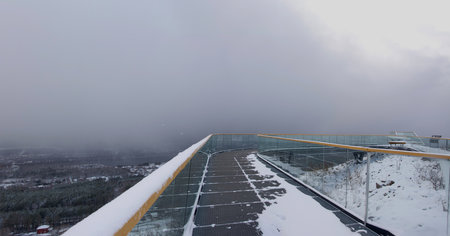 Panoramic view from the observation deck at the top of the mountain in winter on a cloudy day in bad...