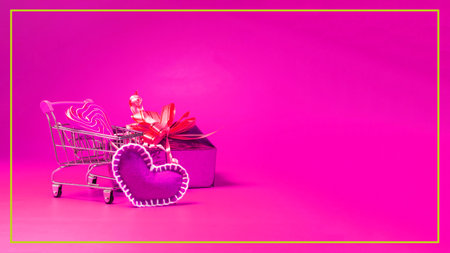 The festive background is a postcard, a basket with a red lollipop, a gift and a red heart.の写真素材