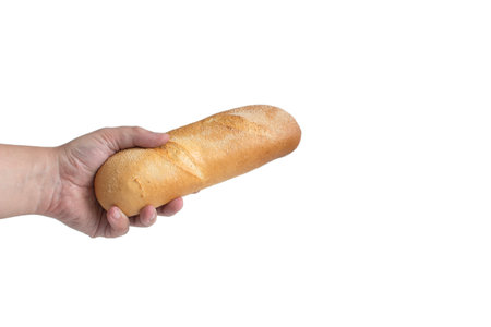 A hand holds out a bread baguette, close-up on a white background, isolateの写真素材
