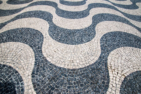 Typical Portuguese calcada mosaic cobble stone paving, Lisbon, Portugal.