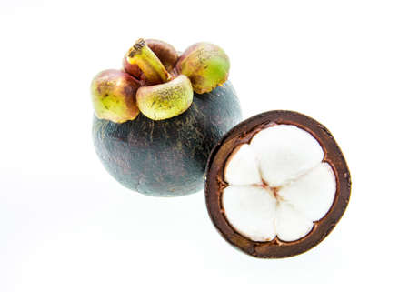 Mangosteen fruit and cross section showing the thick purple skin and white flesh of the queen of fruits の写真素材