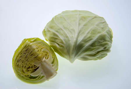 The whole cabbage and a half of cabbage on white backgroundの写真素材