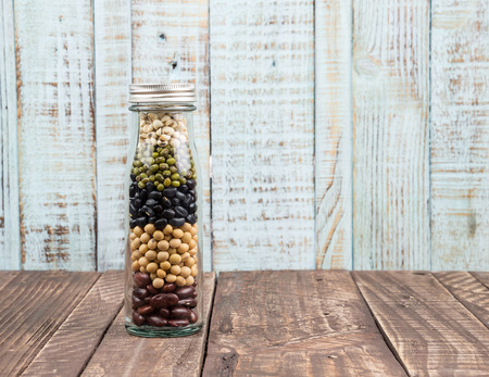 Collection of cereals, beans and grains on wood backgroundの写真素材