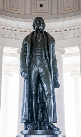 Bronze statue of Thomas Jefferson in front of engraved wall with text of the American Declaration of Independence at the president memorial in Washington DCの写真素材
