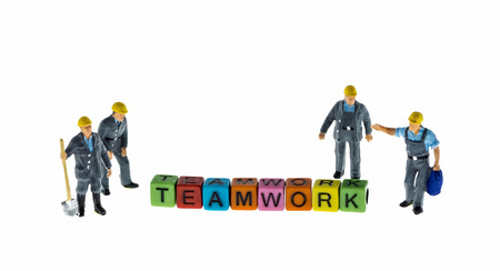 construction man miniature figure with teamwork wordの写真素材
