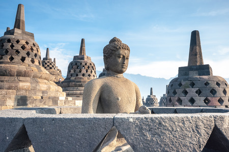 Ancient Buddha statue and stupa at Borobudur temple in Yogyakarta, Java, Indonesia.の写真素材