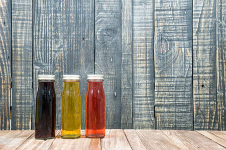 Juice bottle on vintage wooden backgroundの写真素材