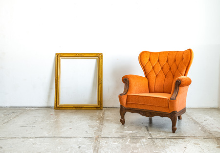 Luxurious classical vintage armchair with empty classic frame on white backgroundの写真素材