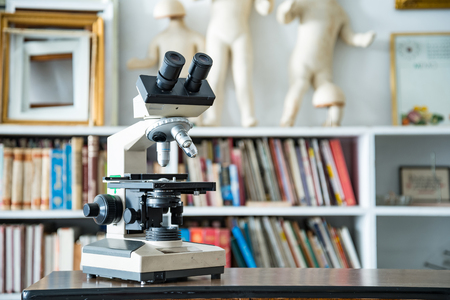 Chemical laboratory microscope in blur vintage room interior