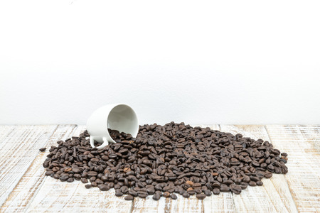 Coffee cup with roasted coffee beans on wooden tableの写真素材