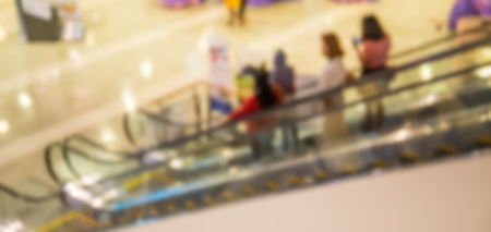 Blurred shopping mall corridor with people walkingの写真素材