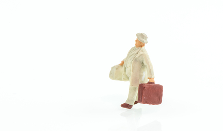 Miniature people business traveler concept on white background with a space for textの写真素材