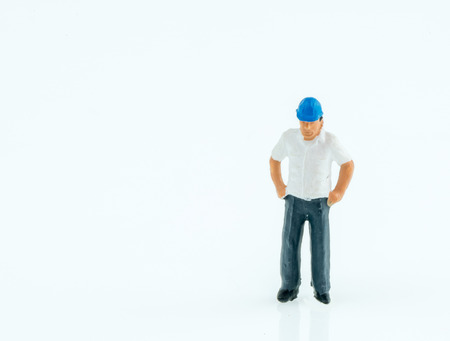 Miniature people engineer worker construction concept on white background with a space for textの写真素材
