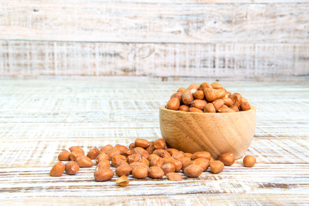 Peanut in a cup on a wooden background.の写真素材