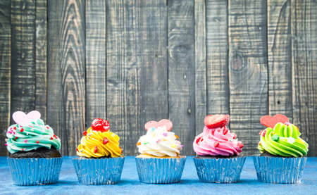 Colorful Cupcake on wood vintage backgroundの写真素材