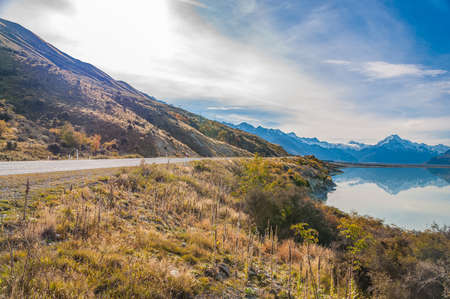 Regional road at Lake Pukaki with Mt. Cook in background (the highest mountain in New Zealand)....