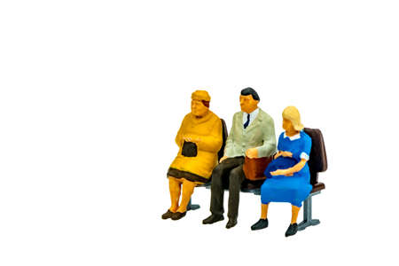 Miniature people office, worker and business sit on chair concept in variety action on white background with space for textの写真素材