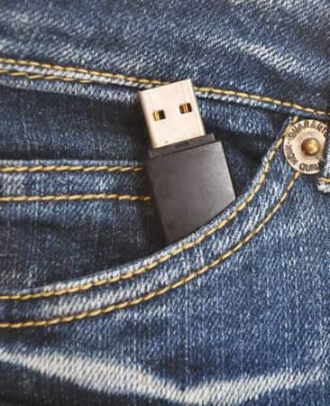 Flash memory in jeans pocket - technology background