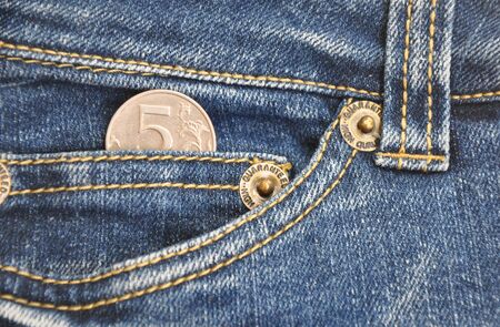 Coin in your pocket jeans. Business concept. Close up