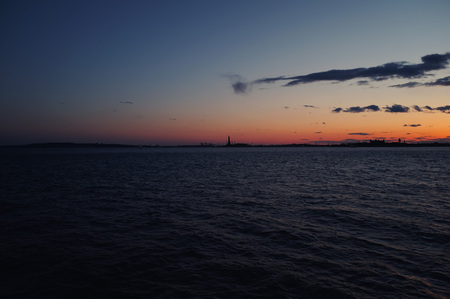 New York City skyline with urban skyscrapers over Hudson River at sunset. Manhattan downtown panorama. Waterfront view to the harbor at twilight.の写真素材