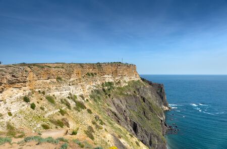 Fiolent Cape Crimea Black Sea. Blue azure seaside with corals sand and stones